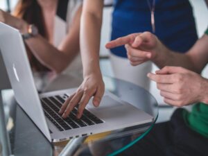 A mac on a table showing why data rooms for investors are essential