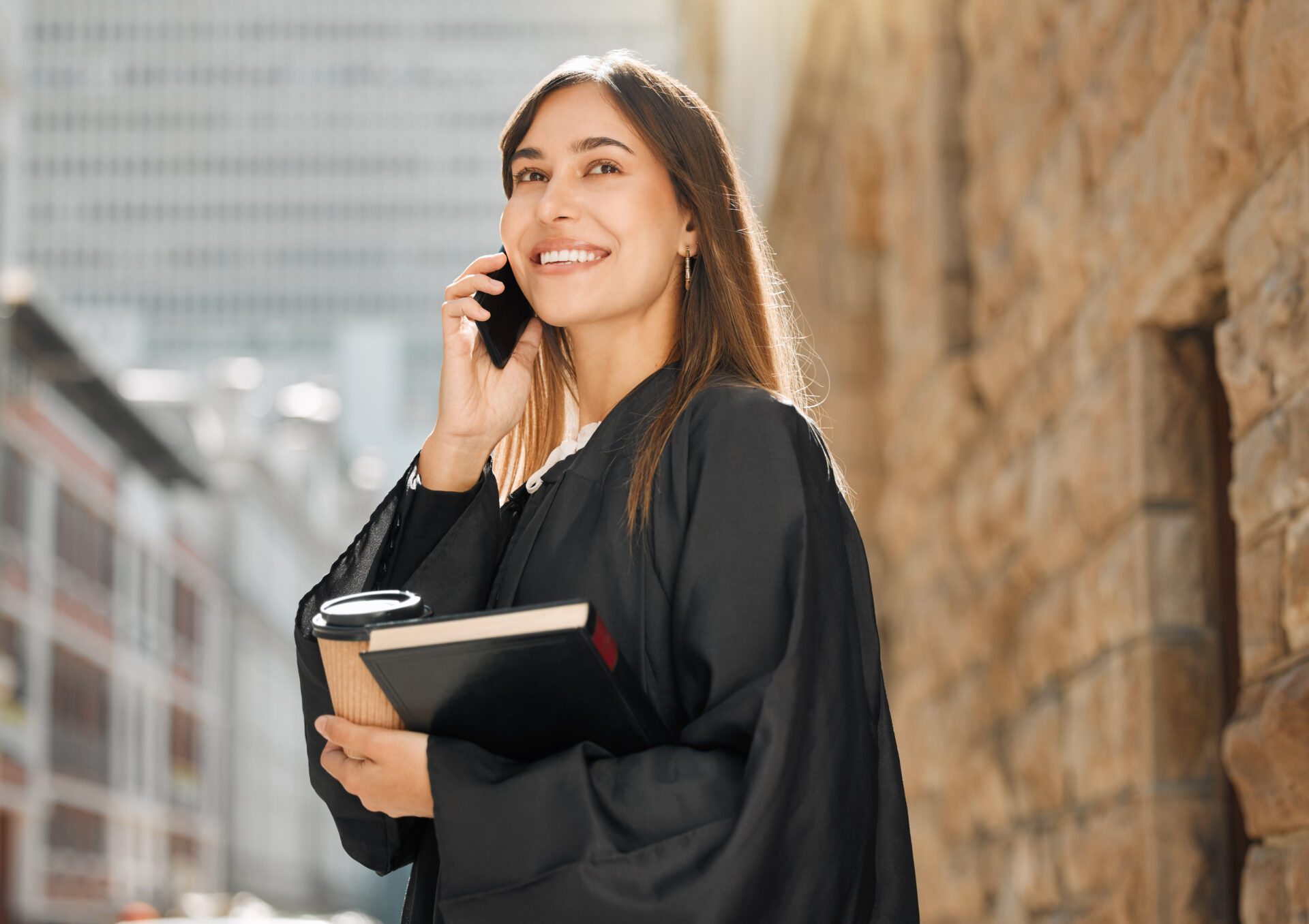 Shot of a young female judge using her smartphone to make a call.