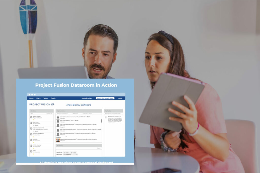 A business man and woman reviewing work on their laptop with the projectfusion data room on the image