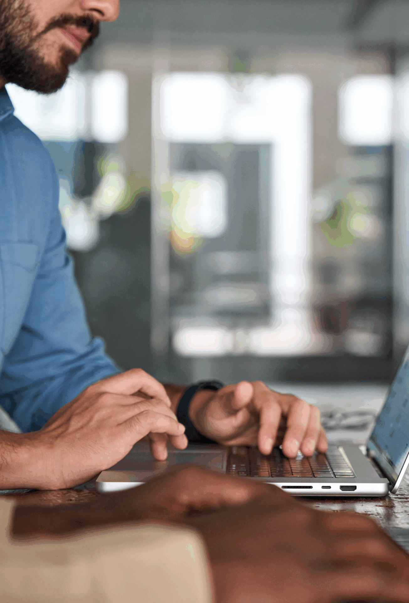 Professional business people, two male employees workers using computers technology working in office. Busy diverse business men team typing on laptop sitting at work desk. Close up photo.